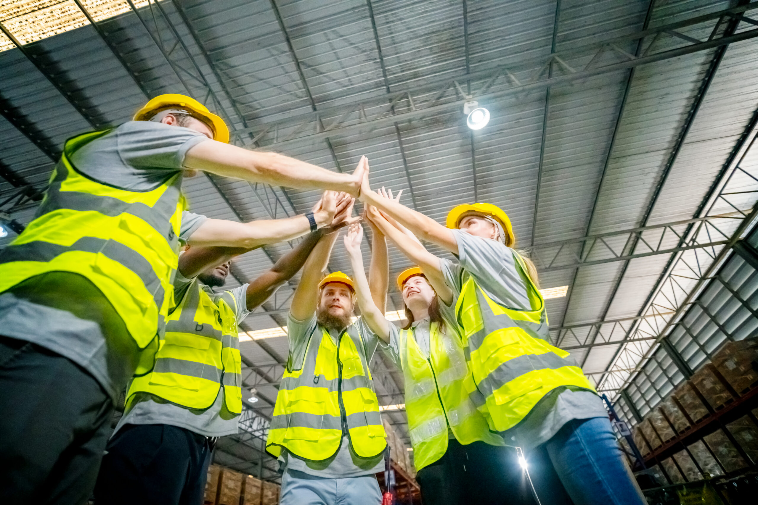 Warehouse workers checking inventory in a large distrubiton warehouse.